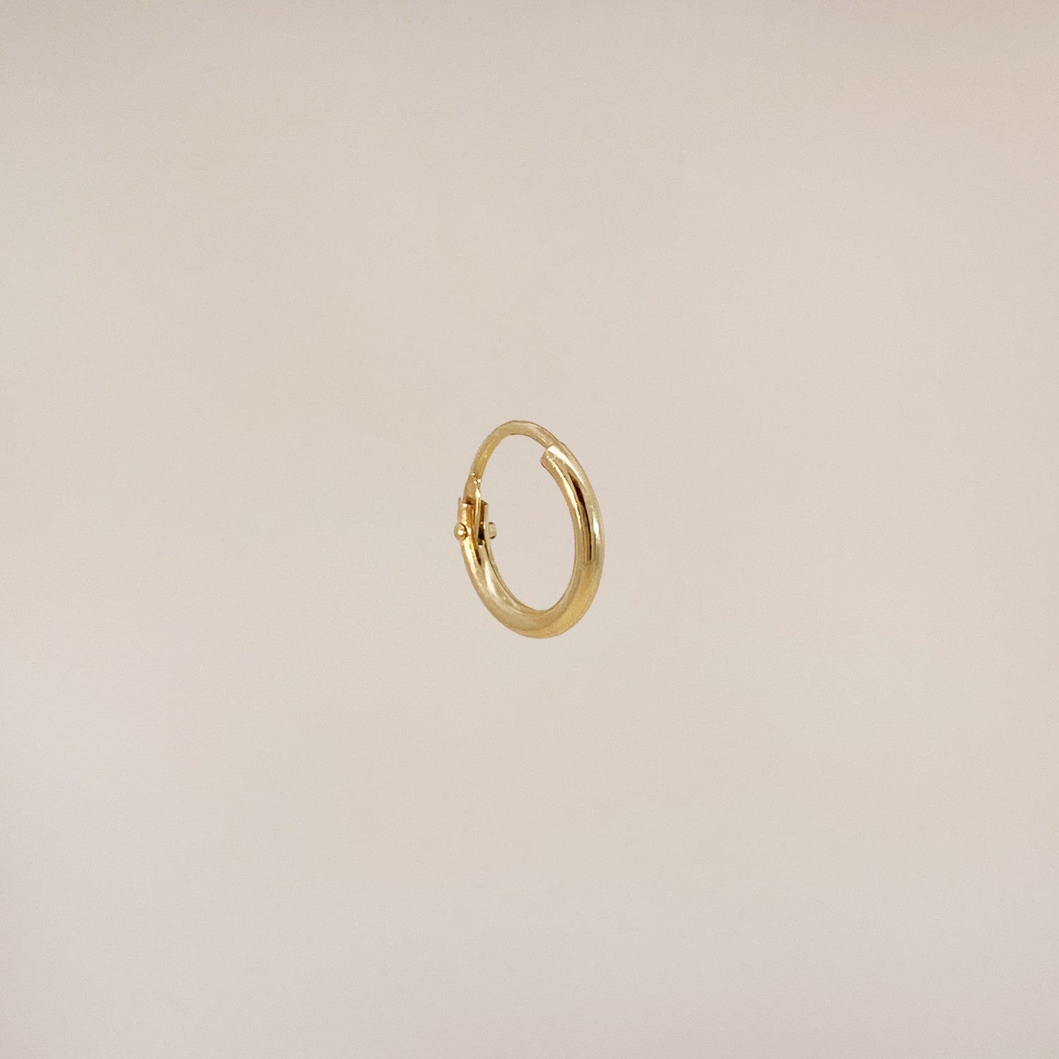 Tiny gold huggie