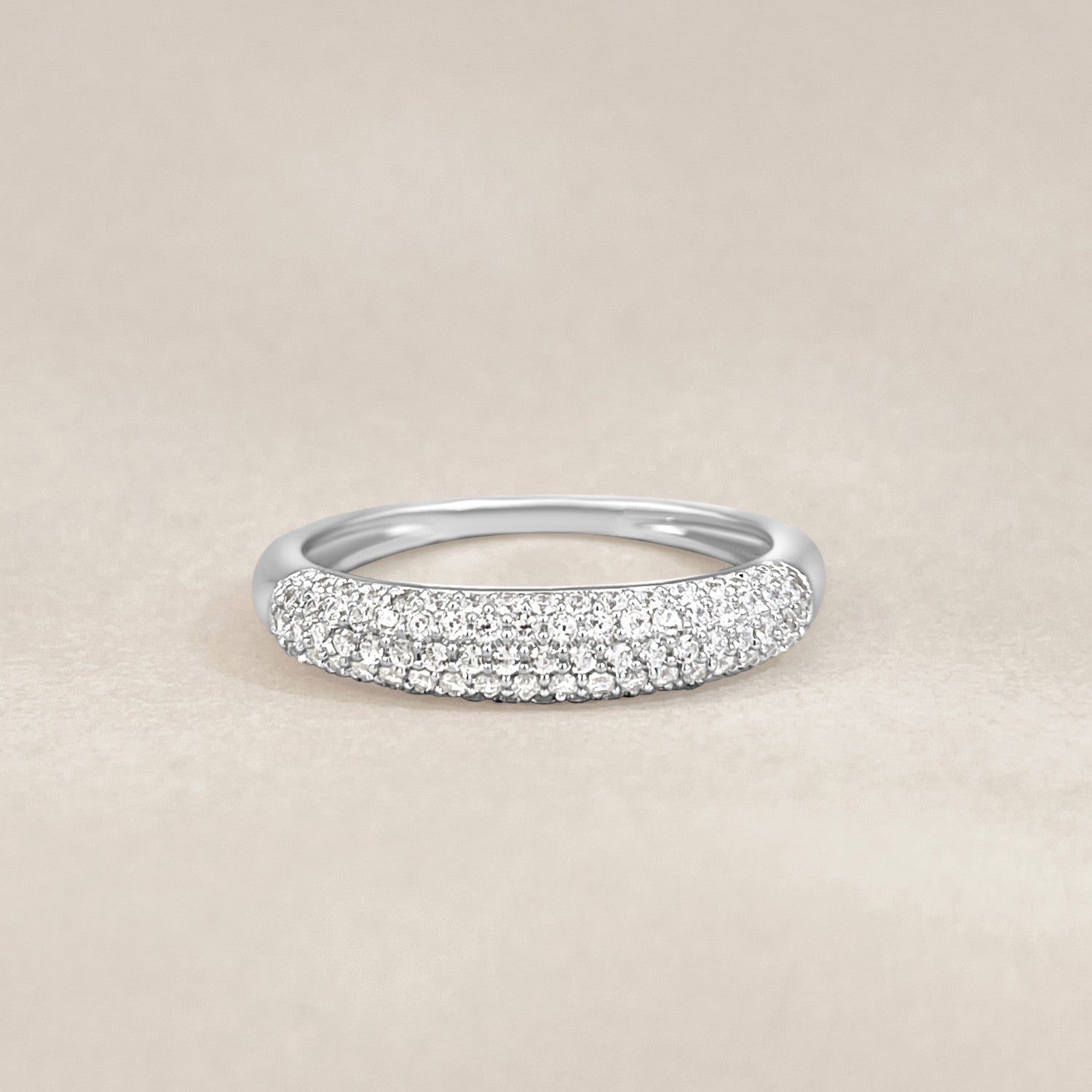 Silver ring with small crystals on a beige background